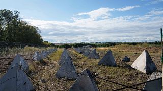 An anti-tank system known as "dragon teeth" covers a field on the Russian-Ukrainian border in the Sumy region of Ukraine,