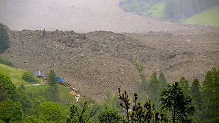A large avalanche with a mixture of ice, rock, snow and water reach the valley floor after the Birch glacier collapsed above Blatten, Switzerland, Wednesday, May 28, 2025
