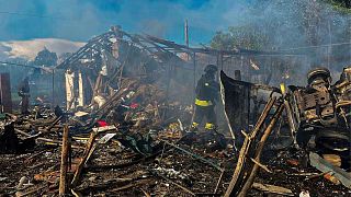 Firefighters extinguish a fire following Russia's air raid in the Sumy region.