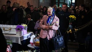 A woman cries during a funeral ceremony for Tamara, Stanislav and Roman Martyniuk, killed in a Russian strike on Sunday, in Zhytomyr region, Ukraine, Wednesday, May 28, 2025. 