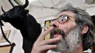 FILE: A man smokes a cigarette in a bar on World No Tobacco Day in Cordoba, 31 May 2005