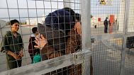 A Syrian migrant embraces his wife after she arrived with their children at a refugees camp at Kokkinotrimithia outside Nicosia, 4 February, 2017