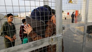 A Syrian migrant embraces his wife after she arrived with their children at a refugees camp at Kokkinotrimithia outside Nicosia, 4 February, 2017