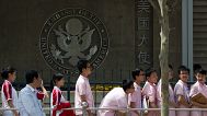 Chinese students wait outside the U. Embassy for their visa application interviews in Beijing, 2 May, 2012