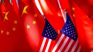 American flags are displayed together with Chinese flags on top of a trishaw. 16 Sept. 2018.
