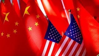 American flags are displayed together with Chinese flags on top of a trishaw. 16 Sept. 2018.