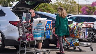 People pack their supplies into their vehicles at Costco Wholesale store in Burbank, California. 10 April 2025.