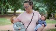 Ana Paula Vilela holds her dolls during a group gathering to bond and show off their hyper-realistic reborn baby dolls, in a park in Sao Paulo, Saturday, May 24, 2025. 