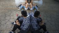 Teenagers take a smoking break.