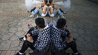 Teenagers take a smoking break.