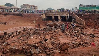 People search in flooded area following a downpour in Mokwa, Nigeria, Friday, May 30, 2025.