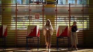 A woman prepares to cast her vote during the presidential election runoff in Warsaw, Poland, Sunday, June 1, 2025. 