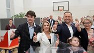 Presidential candidate Karol Nawrocki poses with family members after voting at a polling station during the presidential election runoff in Warsaw, 1 June 2025