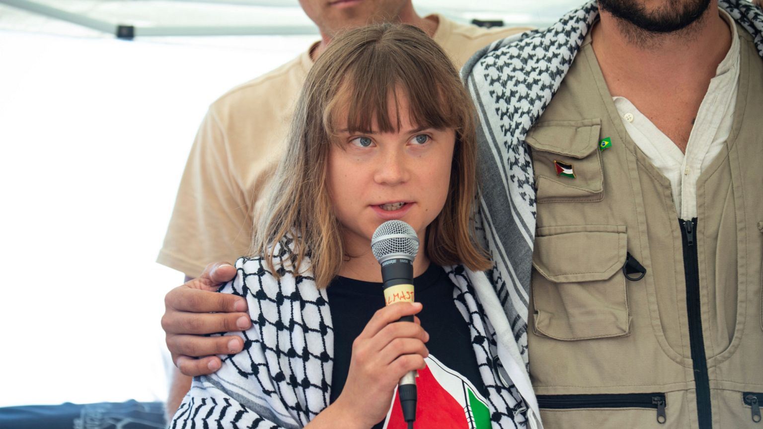 Climate activist Greta Thunberg flanked by Thiago Avila from a human rights organization meets with journalists in Catania,