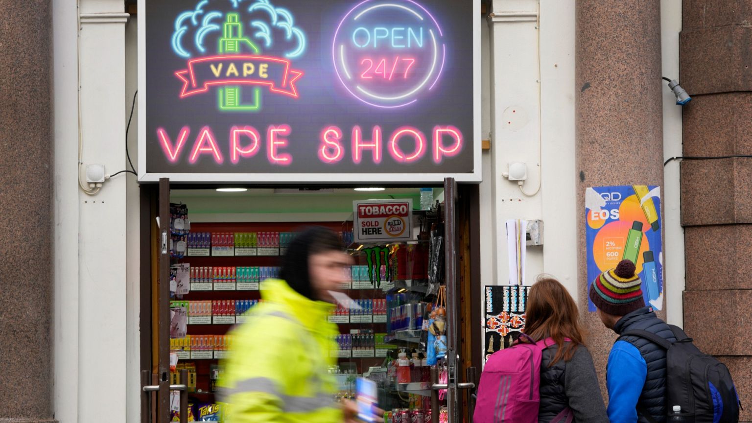 Pedestrians pass a vape shop in London, Monday, Jan. 29, 2024.