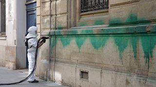 A worker cleans the defaced with green paint Synagogue des Tournelles after several Jewish sites across the capital were defaced with green paint, 31 May 2025