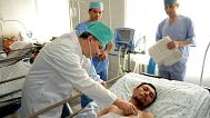 A doctor inspects a wounded Uzbek refugee Nabijon Kuchkarov who fled from the southern Kyrgyz city of Osh, 16 June, 2010