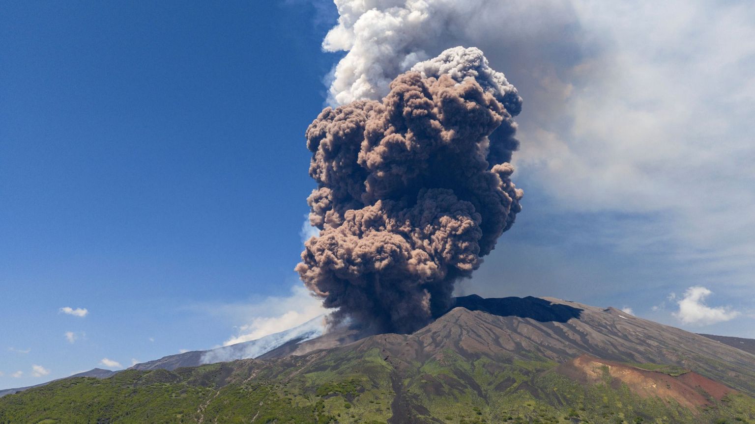 Smoke billows from Mount Etna volcano, Italy.