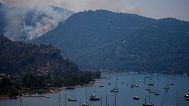 FILE- A wildfire burns the forest in Turgut village, near tourist resort of Marmaris, Mugla, Turkey, Wednesday, Aug. 4, 2021. 