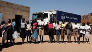 Children wait in line to receive aid during a visit organised by The World Food Program in the town of Kauda, 9 January, 2020