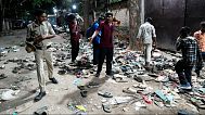 People rummage through footwear outside a stadium after a stampede caused by fans celebrating Royal Challengers Bengaluru's victory in the IPL, Benngaluru, India, June 4, 2025