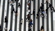 People walk along a shopping street on March 31, 2023, in Tokyo.
