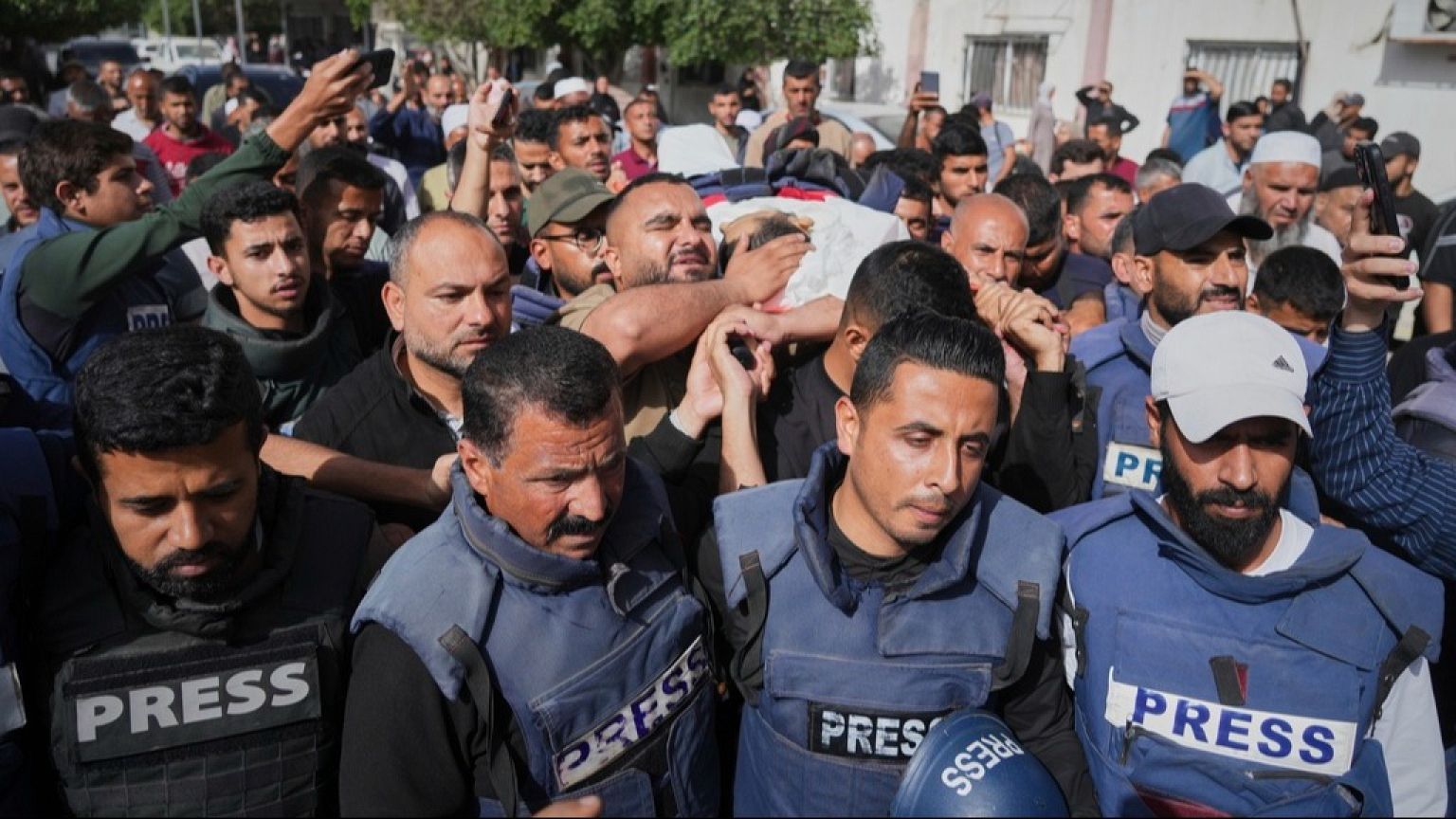 Mourners carry the body of Palestinian journalist Hassan Eslaiah, who was killed in an overnight Israeli strike on Nasser Hospital, Khan Younis, Gaza, Tuesday, May 13, 2025