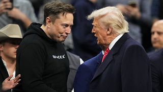 FILE: Elon Musk shakes hands with President Donald Trump at the finals for the NCAA wrestling championship, 22 March 2025