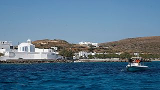 A dinghy leaves from the Aegean Sea island of Milos to Sikinos island, Greece.
