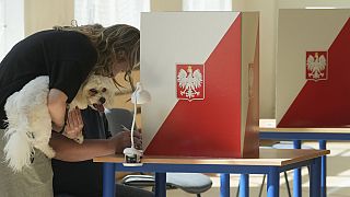 A Polish woman casts her vote in the second round of Poland's presidential election.