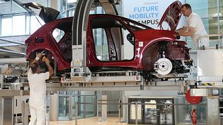 Employees of the German car manufacturer Volkswagen assemble an ID.3 electric car at the transparent factory in Dresden, Germany. 14 May 2025.