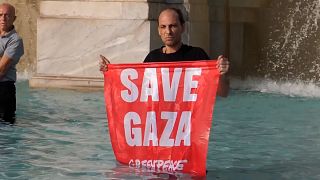A man holds a banner that reads “Save Gaza” in Rome, Italy on June 6, 2025.