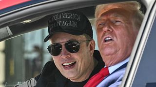 President Donald Trump and Tesla CEO Elon Musk speak to reporters as they sit in a Tesla vehicle on the South Lawn of the White House Tuesday, March 11, 2025, in Washington.