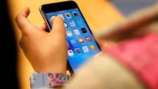 A child holds an iPhone at an Apple store on Sept. 25, 2015 in Chicago.