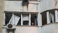 A man looks from a window of a residential multi-storey building damaged after a Russian drone strike on Kyiv, Ukraine, on Friday, June 6, 2025. (AP Photo/Evgeniy Maloletka)