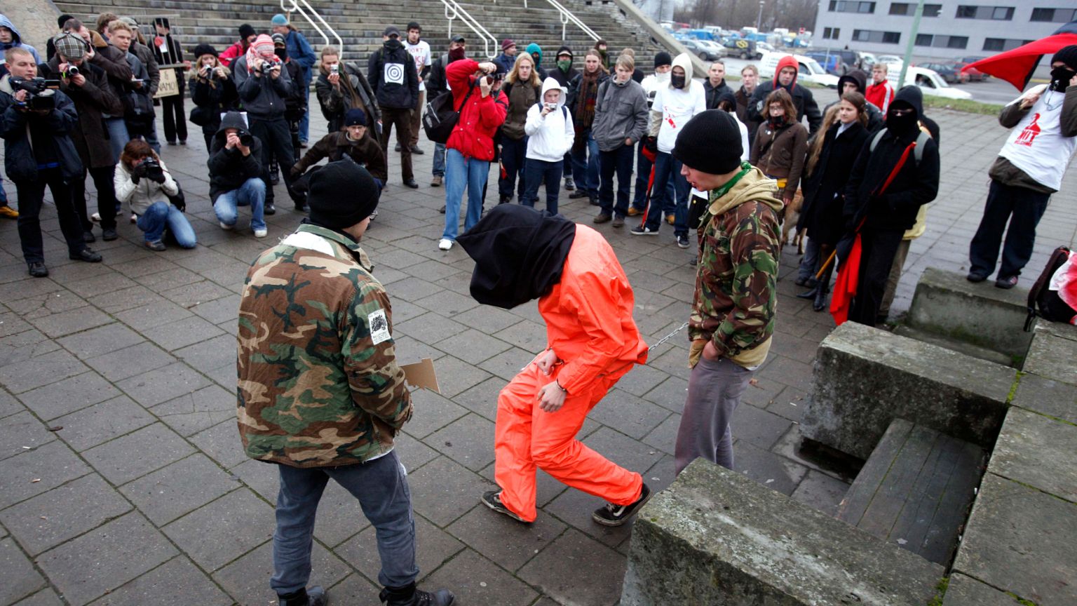 FILE: Protesters, including one wearing a Guantanamo Bay style prison jumpsuit, gather during the visit of US President George W. Bush to Tallinn, Estonia Tuesday Nov. 28, 200