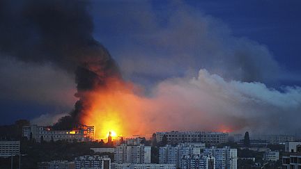Fire and smoke emerge from the site where a Russian missile hit a residential area in Kharkiv, Ukraine, Saturday, June 7, 2025,