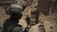 Israeli soldiers stand next to an entrance of a tunnel under the European Hospital in Khan Younis in southern Gaza.