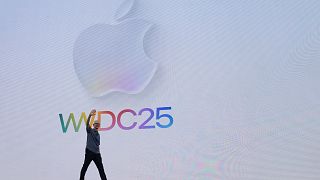 Apple CEO Tim Cook waves to attendees during an event on the Apple campus in Cupertino, Calif., Monday, June 9, 2025.