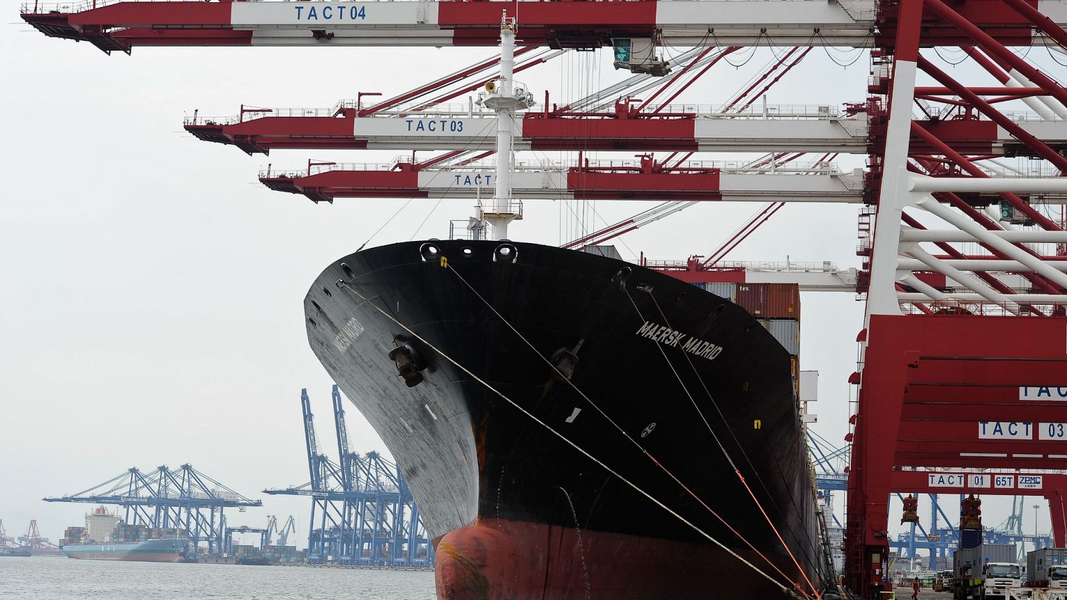 Containers are loaded onto a cargo ship at the Tianjin port in China. 5 Aug. 2010.