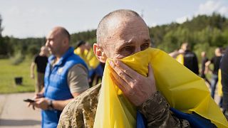Ukrainian soldiers react after returning from captivity during a prisoners' exchange between Russia and Ukraine in Chernyhiv region, 10 June, 2025