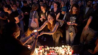 People light candles for victims of a former student who opened fire at a school, killing 10 people before taking his own life, Graz, Austria, Tuesday, June 10, 2025
