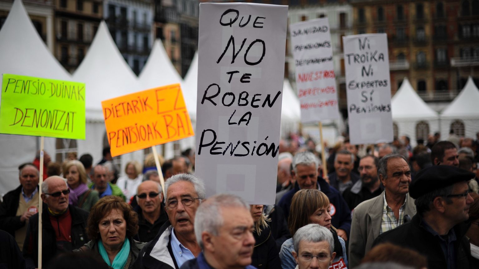 Pensioners holding a banner saying, ''Do not be stealing our pension'' in Spain in 2013.