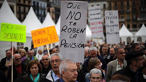 Pensioners holding a banner saying, ''Do not be stealing our pension'' in Spain in 2013.