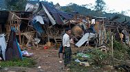 A man looks on at homes destroyed after air and artillery strikes in Mung Lai Hkyet displacement camp in Laiza, 10 October, 2023