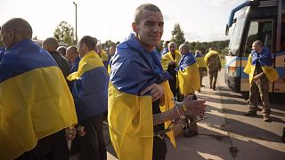 Ukrainian soldiers react after returning from captivity during a prisoners' exchange between Russia and Ukraine, in Chernyhiv region, Ukraine, Tuesday, June 10, 2025. 
