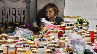 Candles, flowers and a picture placed at the entrance of at a school where a former student opened fire in Graz, 12 June, 2025