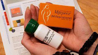 A coordinator shows the medications and care kit that will be sent out abortion patients in May 2025 in the US.
