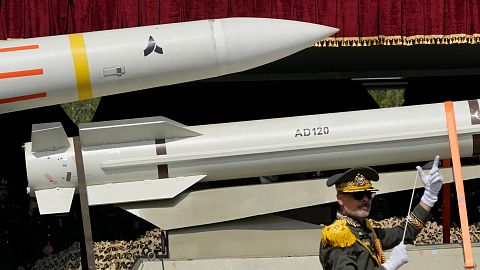 FILE: Missiles are carried on a truck as an Iranian army band leader conducts the music band during Army Day parade at a military base in northern Tehran, April 17, 2024