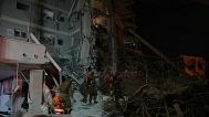 Israeli security forces inspect destroyed buildings that were hit by a missile fired from Iran, near Tel Aviv, Israel, early Sunday, June 15, 2025.